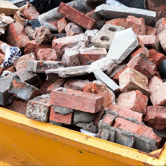 360-homepage-debris-removal bricks in yellow dumpster
