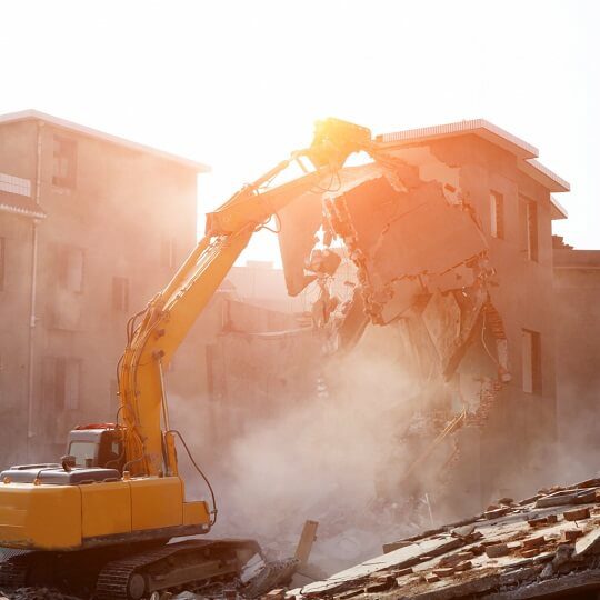 backhoe demolishing building