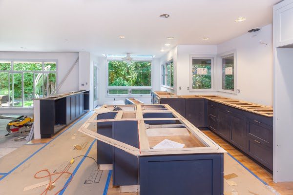 kitchen under construction with cabinets being installed