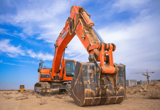 low-angle-photography-of-orange-excavator-under-white-clouds-1078884